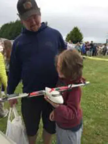 A man with a child holding a model airplane