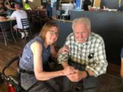 A woman and a man looking at a phone at the table