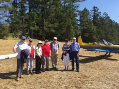 A group of people standing in front of parked airplanes
