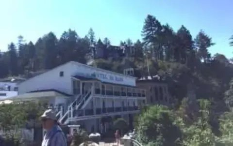 A white resort building surrounded by trees