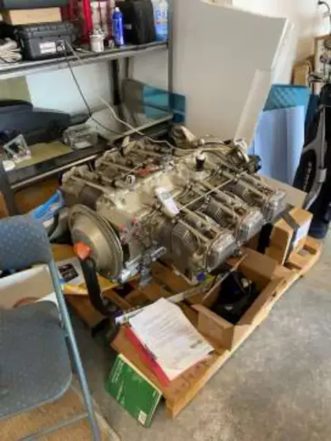 An airplane engine on a crate in a workshop
