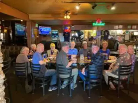 Members seated at tables in a restaurant