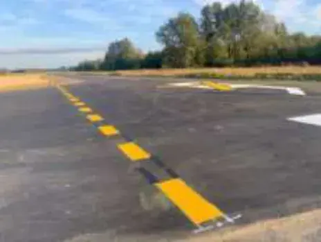 A newly painted runway with yellow taxi line