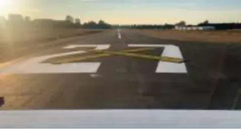 A runway number painted on fresh pavement