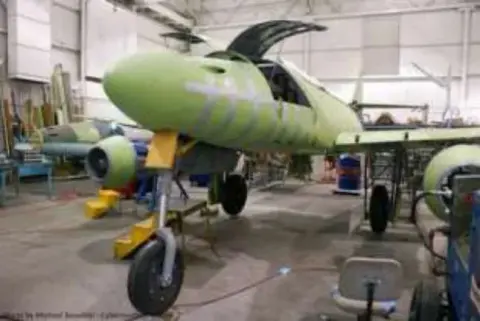 The green Me 262 replica under construction in a hangar