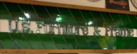 A green awning with a business sign