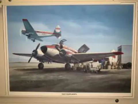 A framed picture of a jet and a propeller airplane