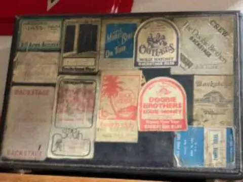 A display case of vintage luggage labels and patches