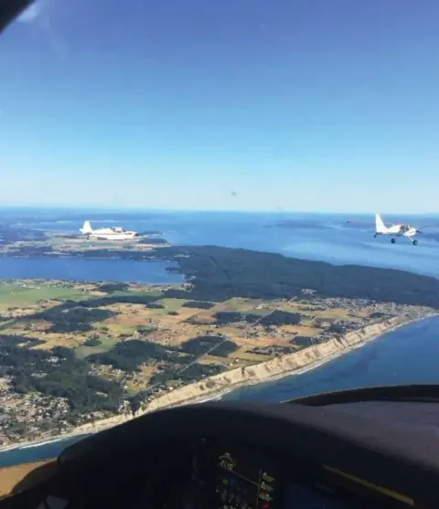 A coastline and city seen from a small airplane