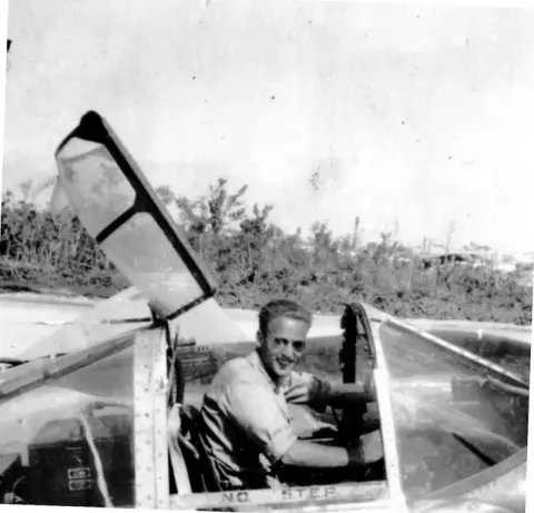 An old photo of a pilot in an open cockpit