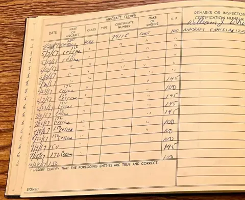 A pilot logbook opened to a page of entries