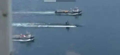Boats speeding across open water