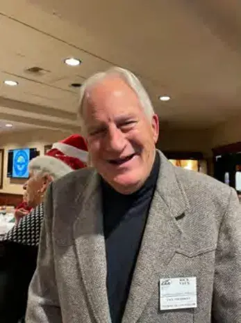 A smiling man in a sport coat and name tag