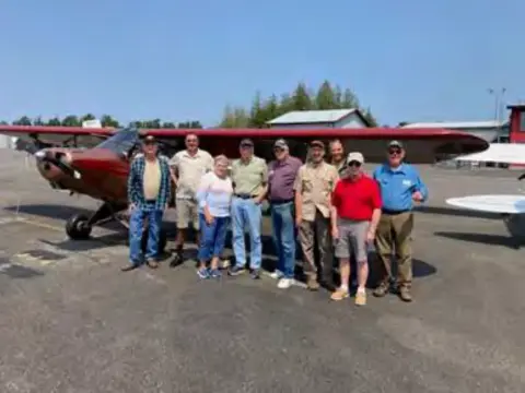 Fly-out members on the ramp and airplanes parked in a row