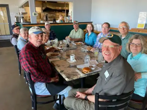 Members at a long restaurant table