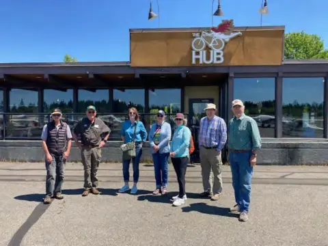 A group of members in front of a restaurant at the airport
