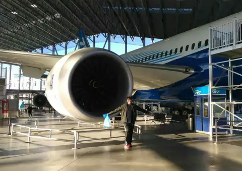 A large jet engine on an airliner in a museum