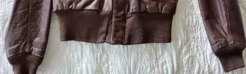 A brown leather flight jacket