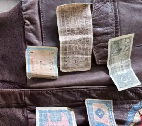 Wartime currency notes pinned to the lining of a leather jacket