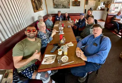 Fly-out group at lunch around a restaurant table