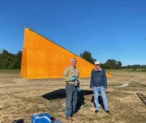 Freshly painted orange tetrahedron wind indicator on the airfield