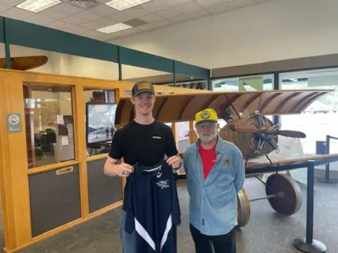 Two pilots standing in an airport terminal doorway