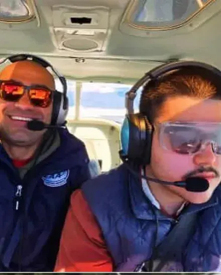 Instructor and student in headsets in a cockpit
