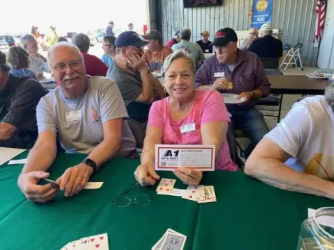 Players around a green poker table