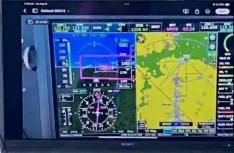 Glass cockpit display showing a moving map and flight instruments