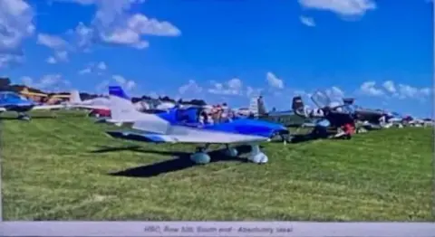 Homebuilt airplanes parked on the grass at Oshkosh