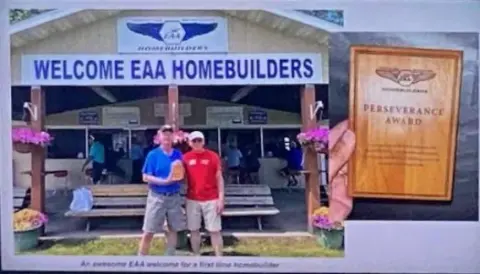 Two men at the Welcome EAA Homebuilders building at Oshkosh