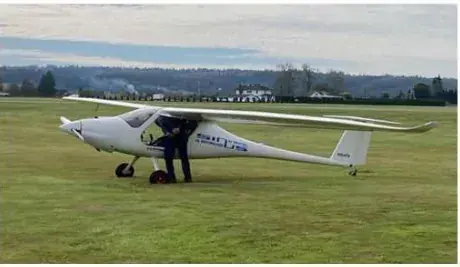White Pipistrel Sinus motorglider parked on the grass