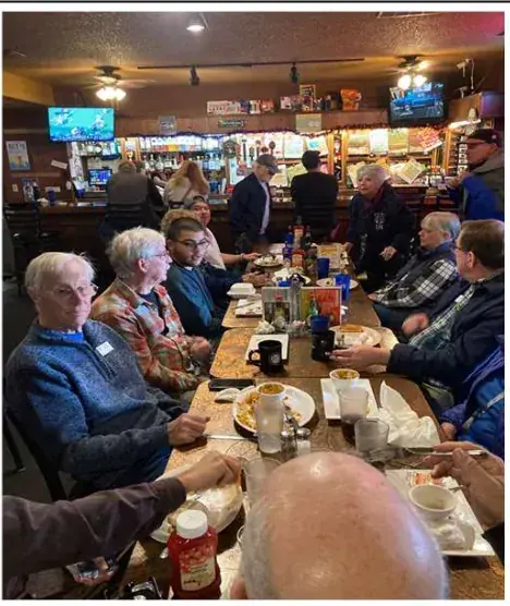 Fly-out group at a long table in a restaurant