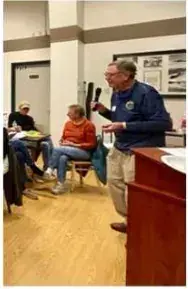 Presenter talking to members in the airport conference room