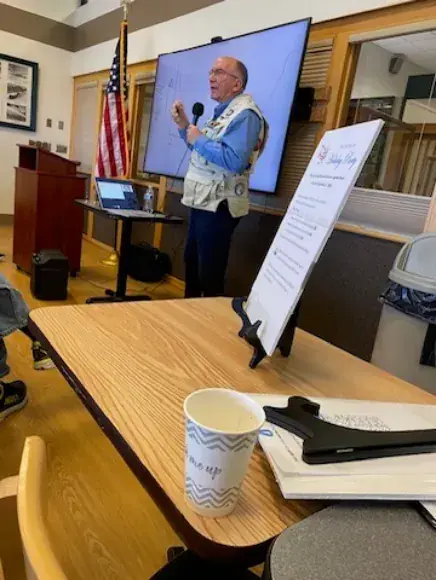 Speaker beside a screen giving a talk on exhaust valves