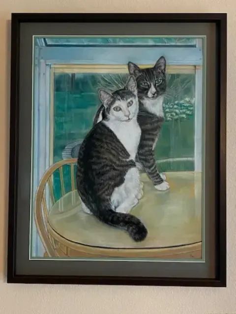 Framed portrait of a cat lying on its back