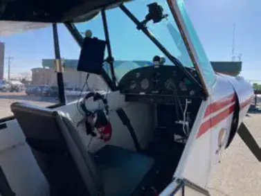 Interior view of a tandem-seat Cub cockpit with the door open