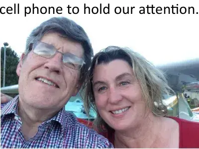 Smiling man and woman taking a selfie outdoors