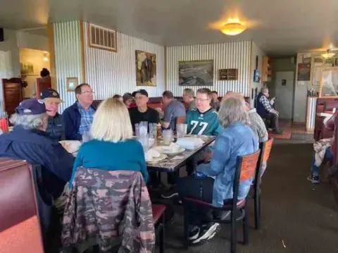 Fly-out group at lunch in a restaurant dining room