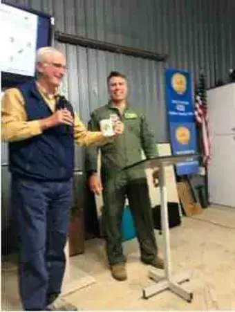 Two men in uniform standing in a hangar during the presentation