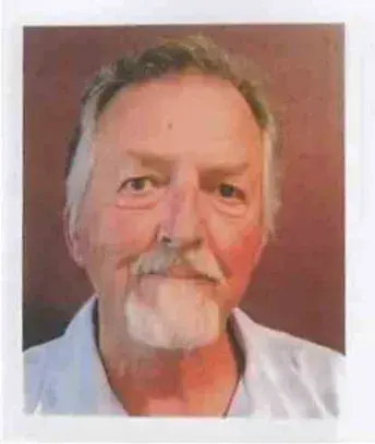 Portrait of an older man with white hair and a gray beard