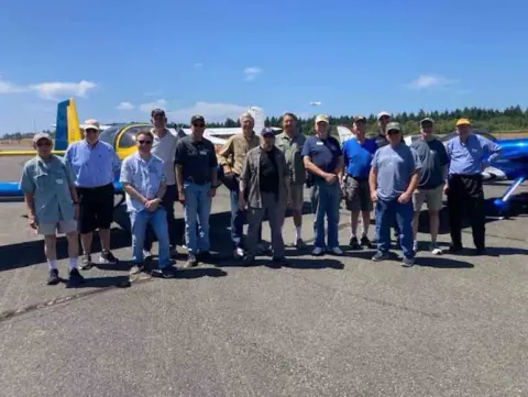 Fly-out group posing on the ramp at Tacoma Narrows