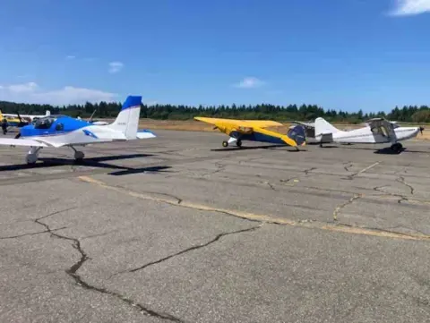 Row of parked airplanes on the ramp at Tacoma Narrows