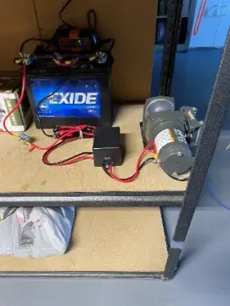 Battery and charger on a shelf, used to power the airplane tug
