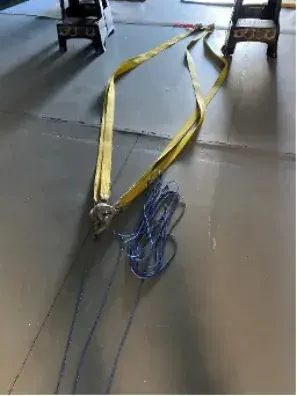Yellow tow strap laid out on the hangar floor