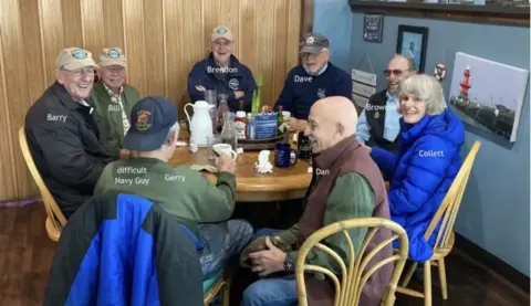 Group of pilots around a café table