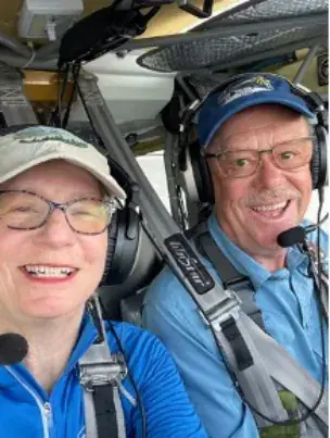 Pilot and passenger in headsets in the cockpit