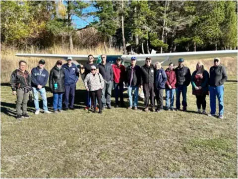Small photo of a group standing on the grass