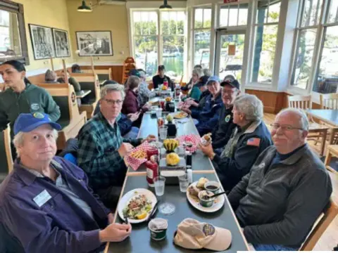 Fly-out group seated around a restaurant table, seen from above