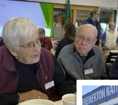 Members eating lunch at a table during a gathering